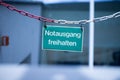 Green emergency exit plate, Ã¢â¬ÅNotausgang freihaltenÃ¢â¬Â, german Royalty Free Stock Photo